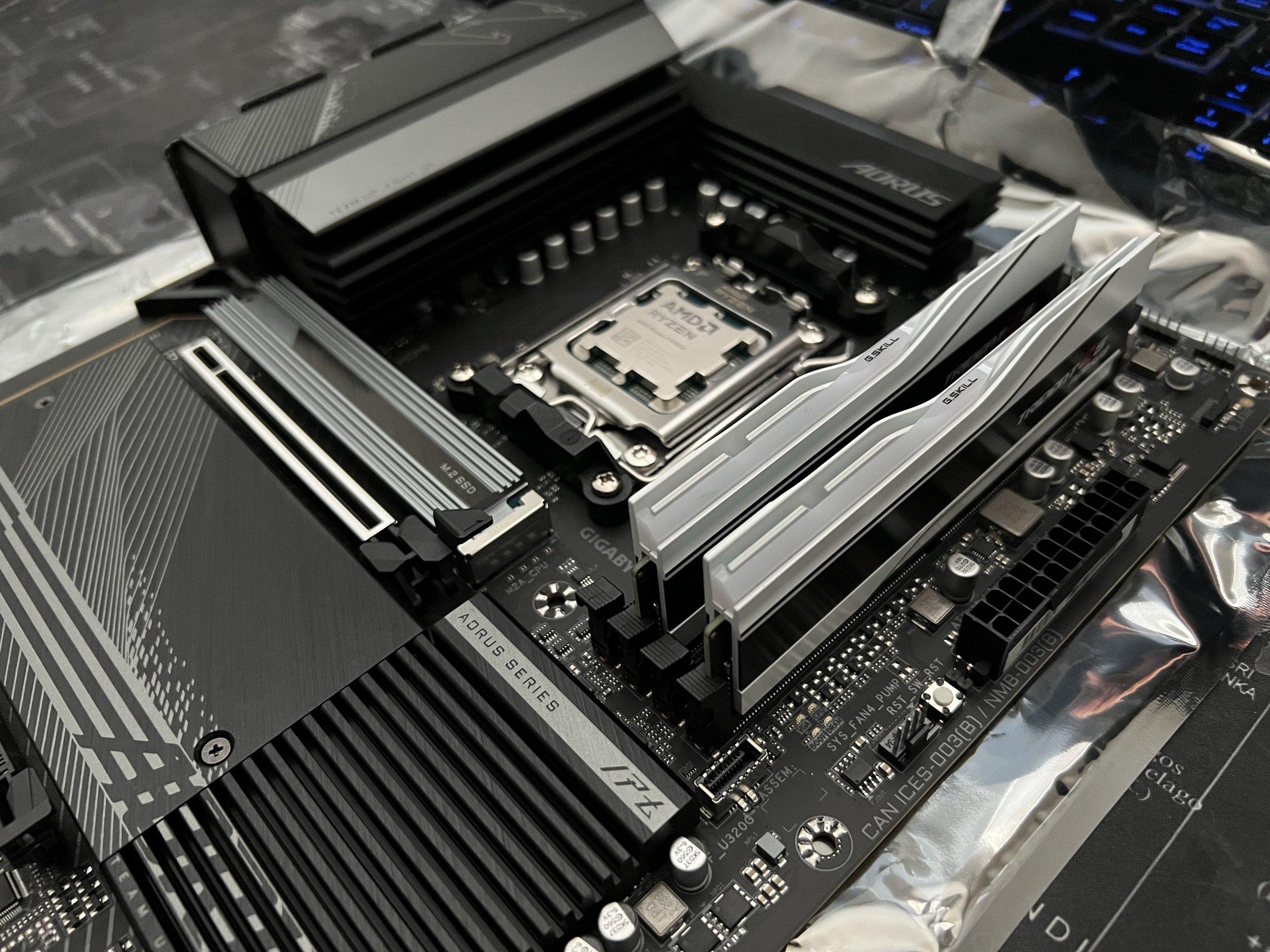 Board assembled The assembled board: 9950X under the retention frame, two RAM sticks, Aorus Elite AX heatsinks