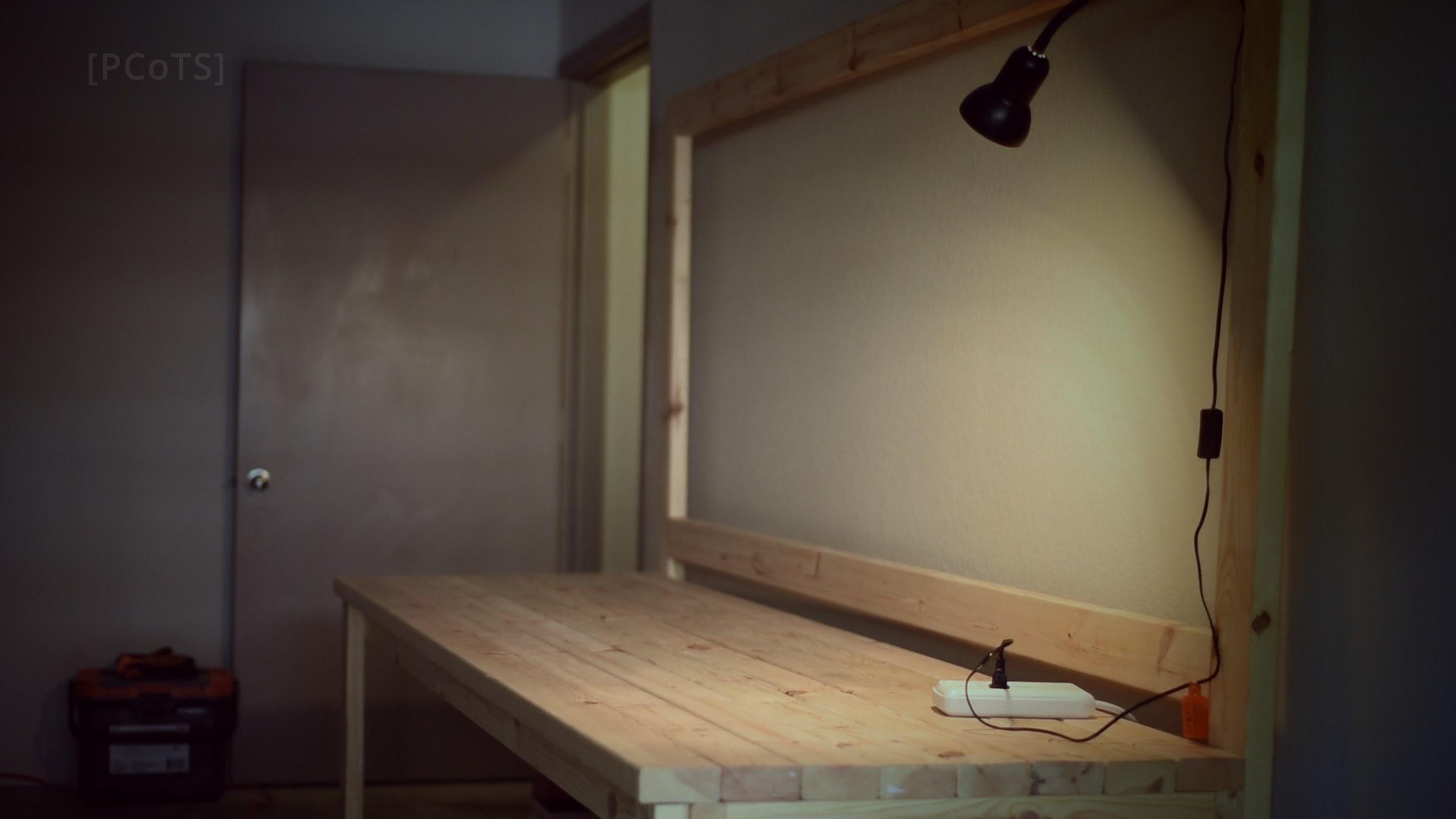 Empty garage workbench with a single lamp