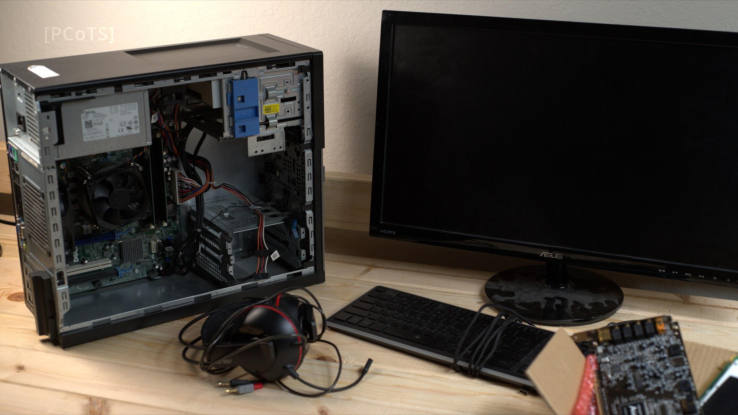 OptiPlex 990 with the side panel off, next to the monitor and headset