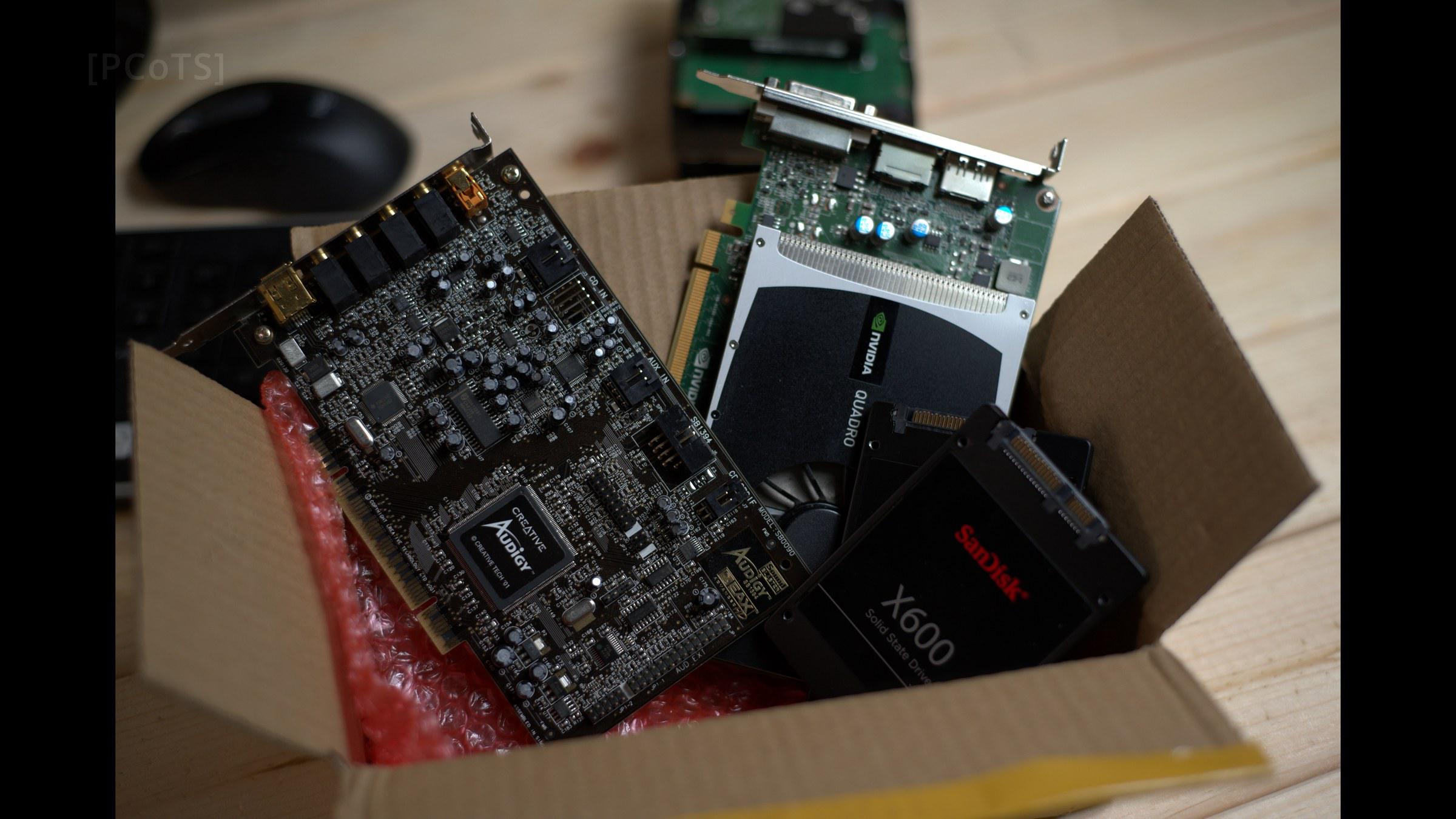 Parts box: Sound Blaster Audigy, low-profile GPU and two SATA SSDs in bubble wrap